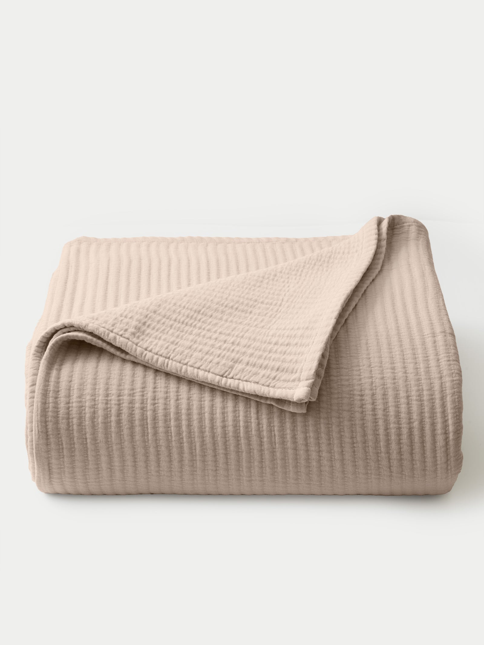 Driftwood coverlet folded with white background 