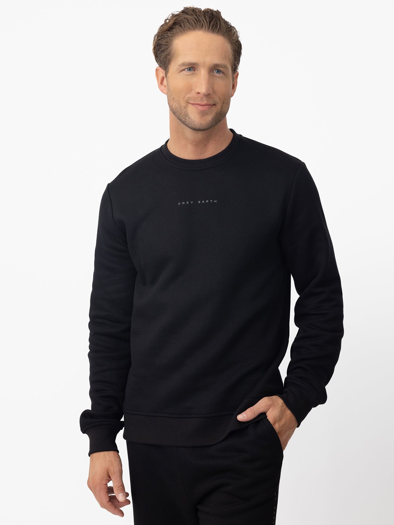 Man wearing black cityscape crewneck with white background 