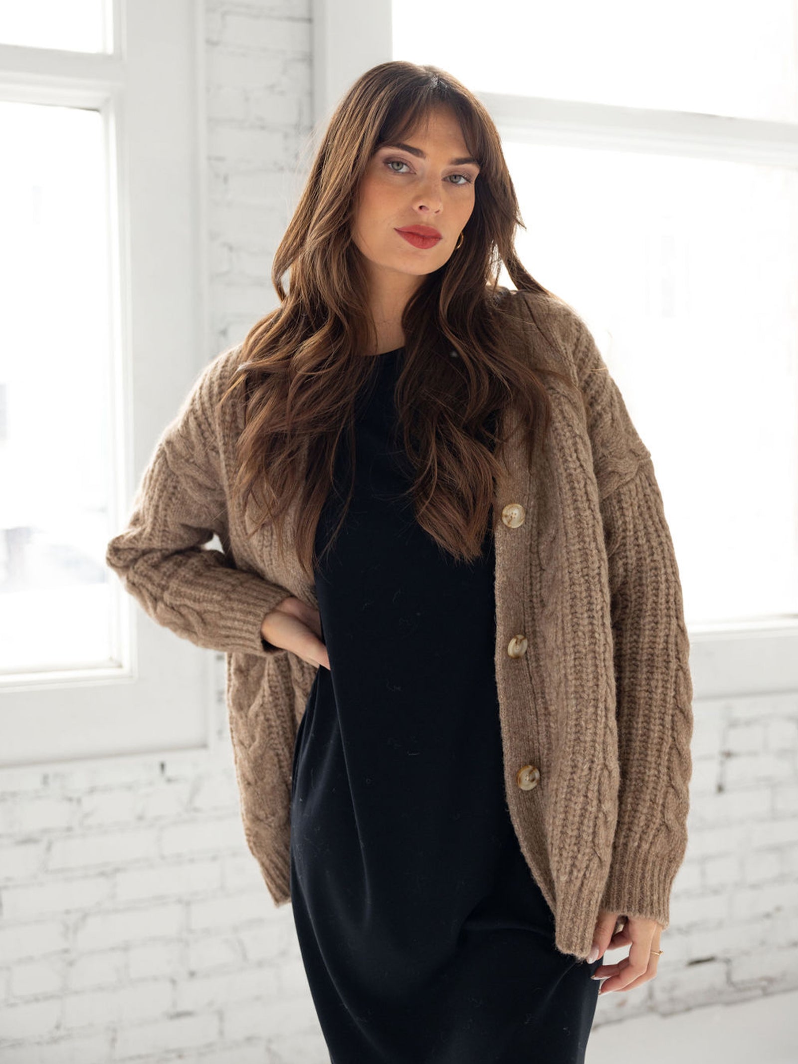 Woman wearing mushroom cardigan over black dress 