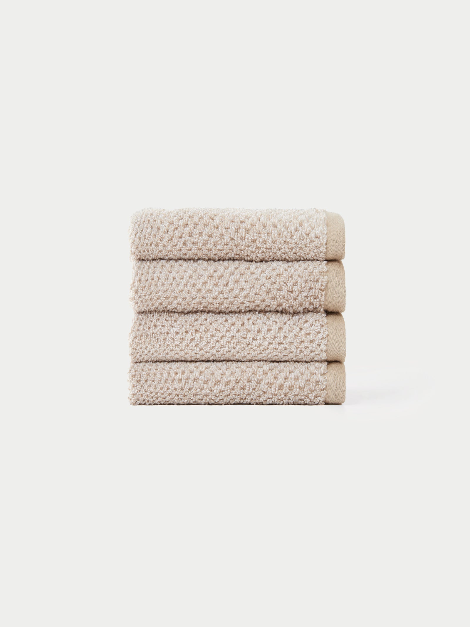 Nantucket Wash Cloths in the color Heathered Sand. The Wash Cloths are neatly folded. The photo of the wash cloths was taken with a white background.