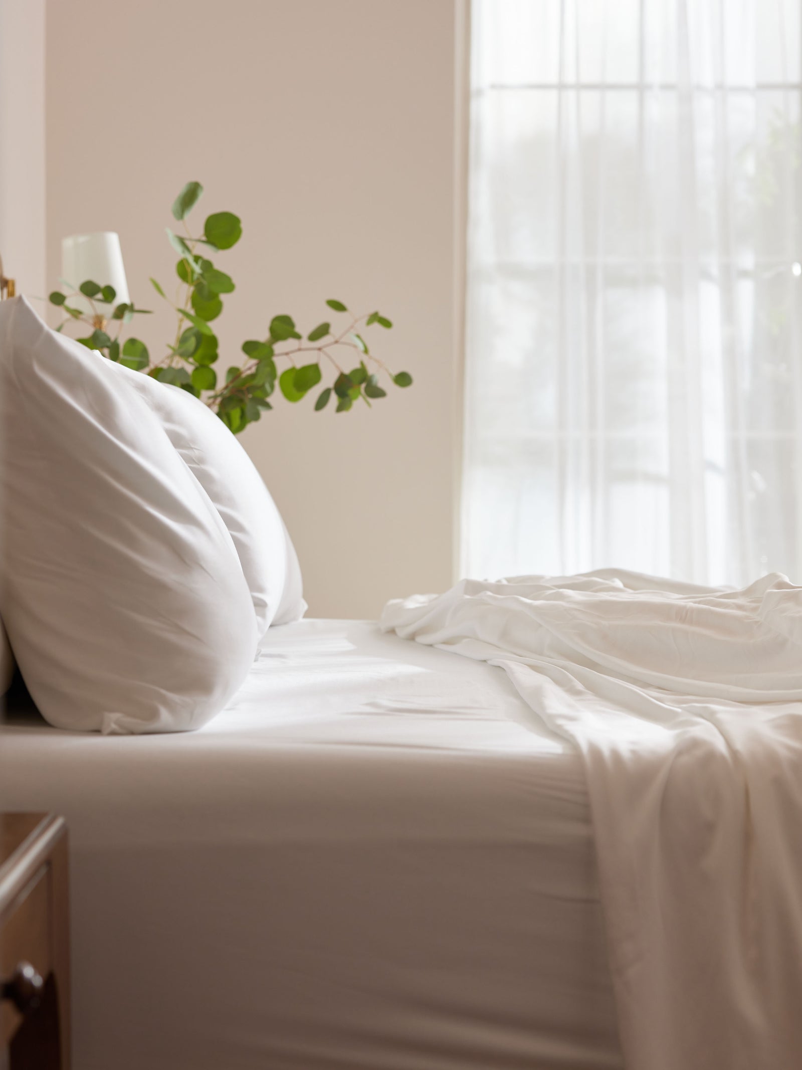 Side view of white bedding on bed 
