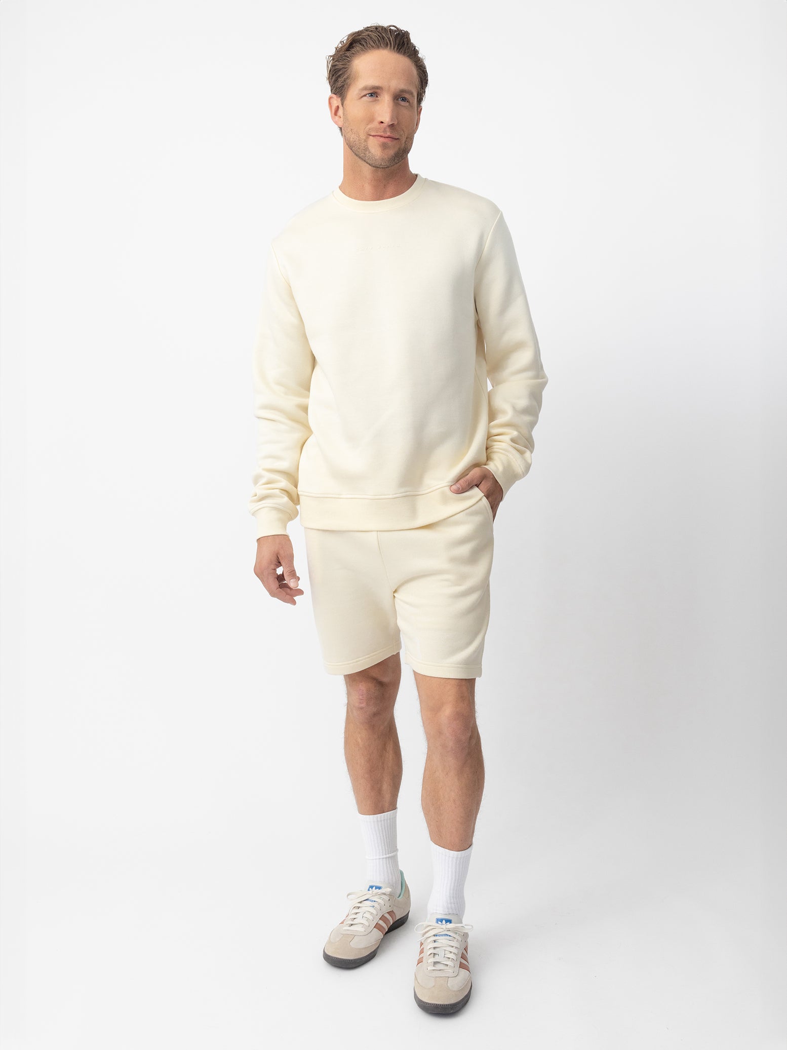 Man wearing Alabaster cityscape crewneck with white background 