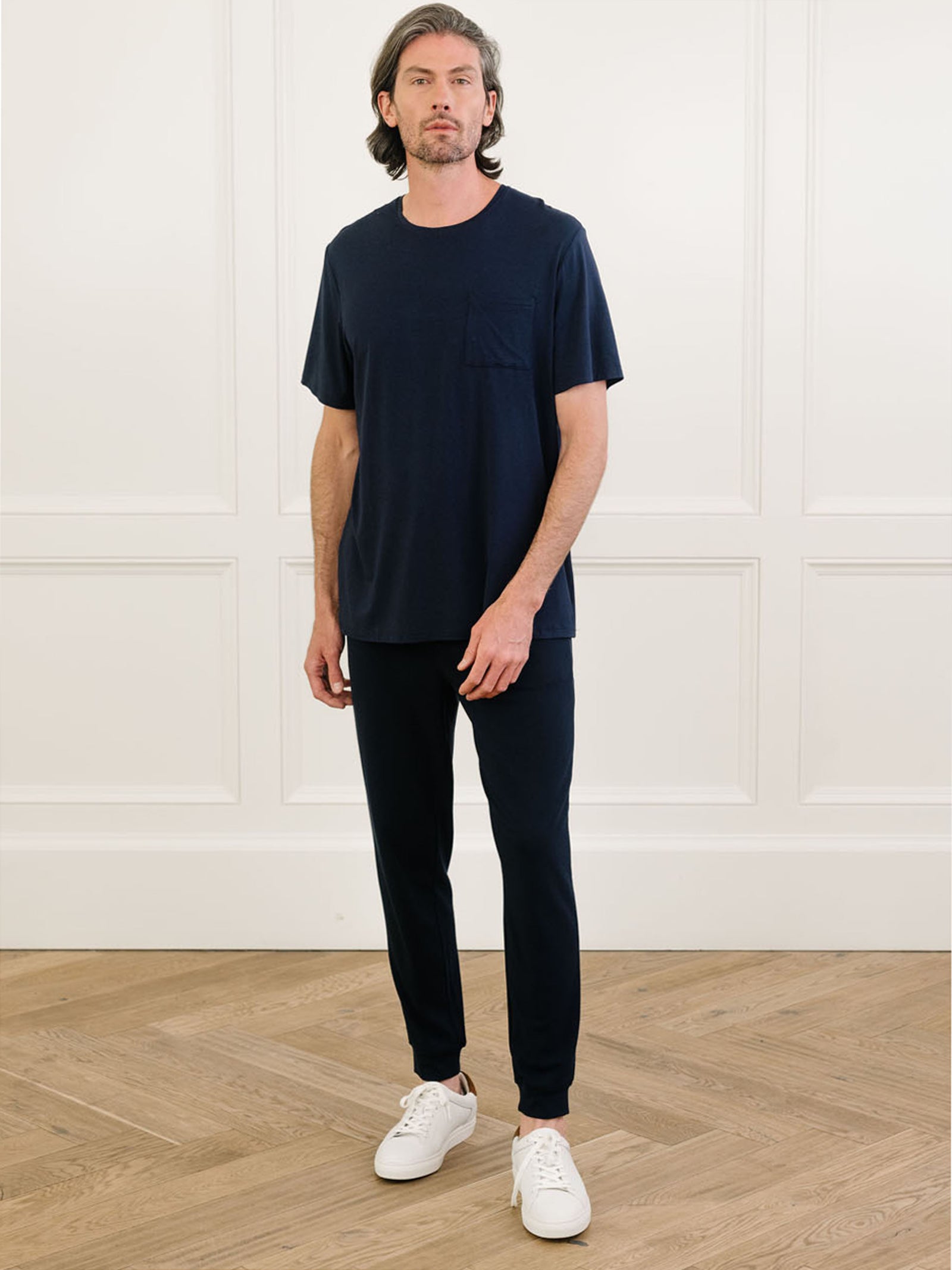 Navy Men's Stretch-Knit Bamboo Lounge Tee. A man is wearing the lounge tee in a well lit home.