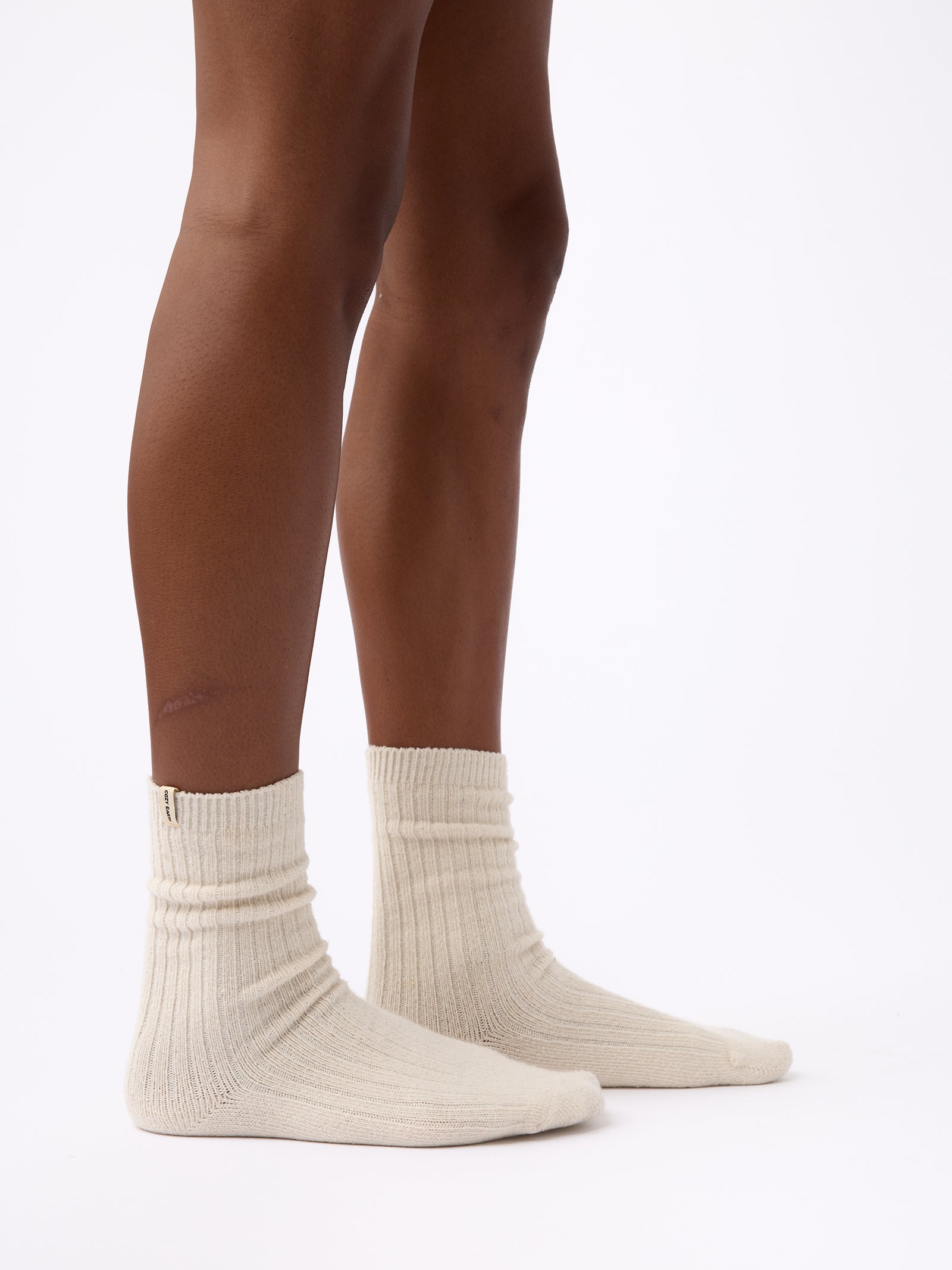 Person wearing Cozy Earth Plush Lounge Sock 1-Pack in Alabaster 