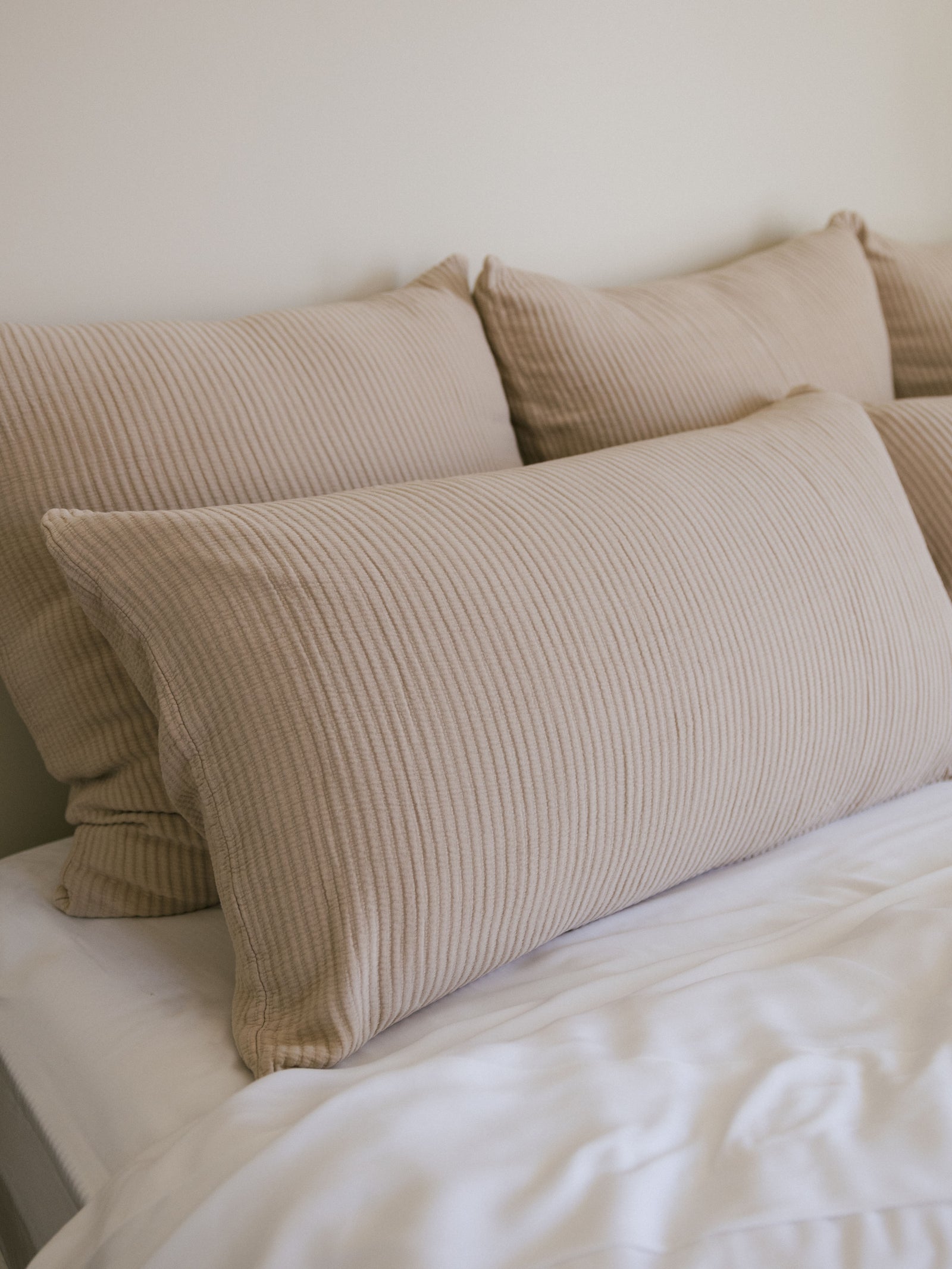 Driftwood coverlet shams on white bed 