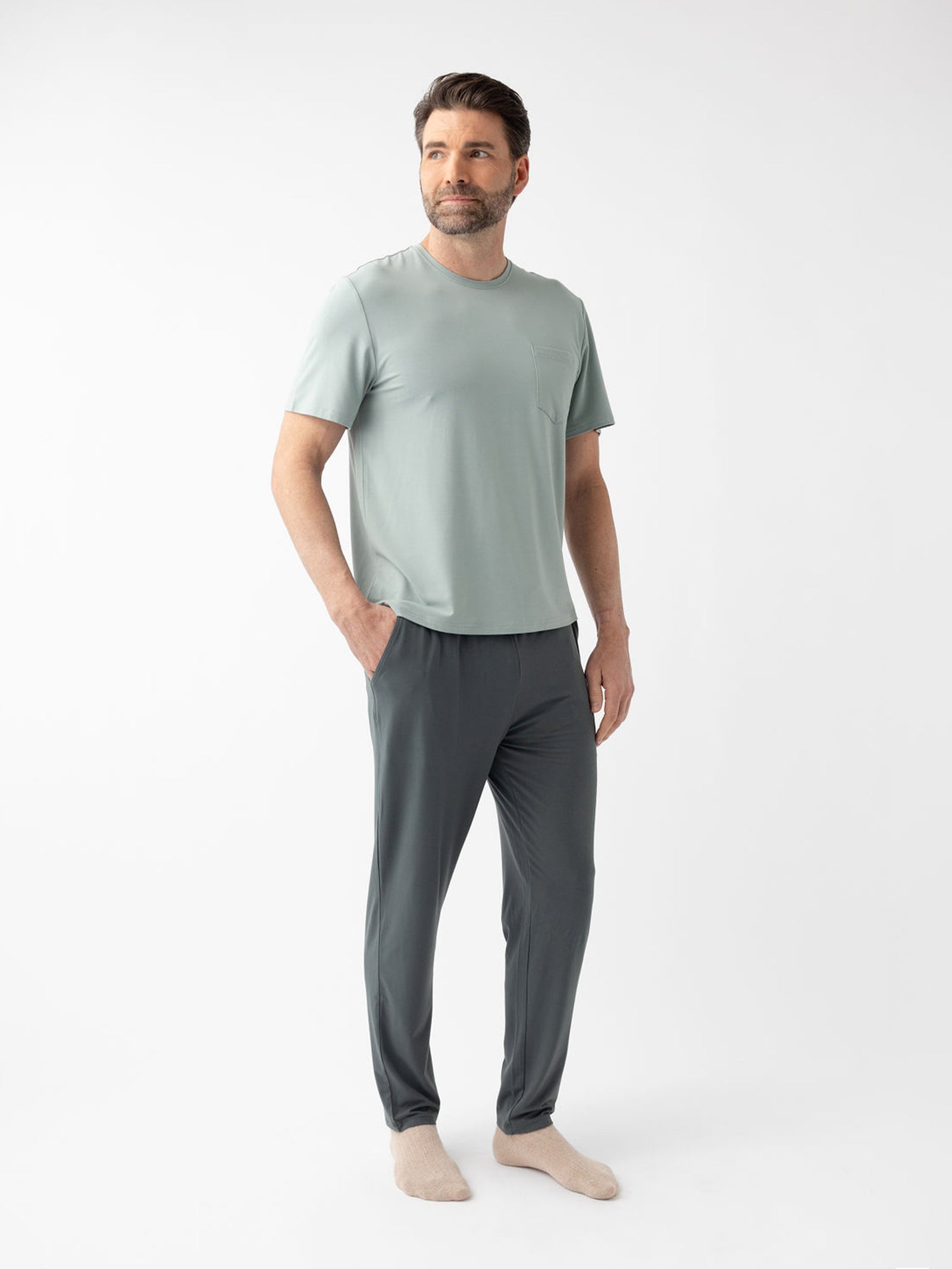 Man wearing storm pajama pants and haze pajama shirt with white background 