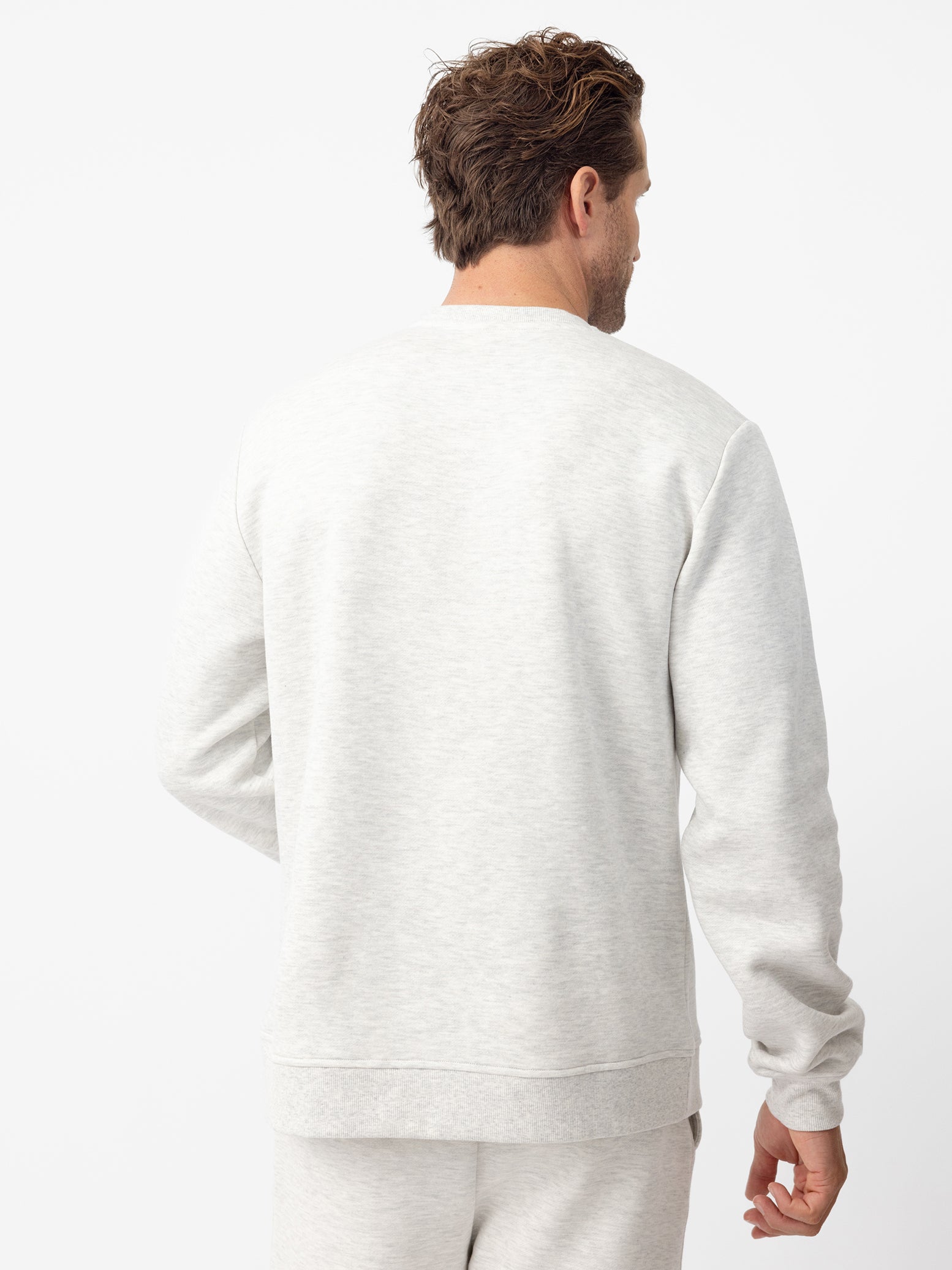 Back of man wearing heather grey cityscape crewneck 