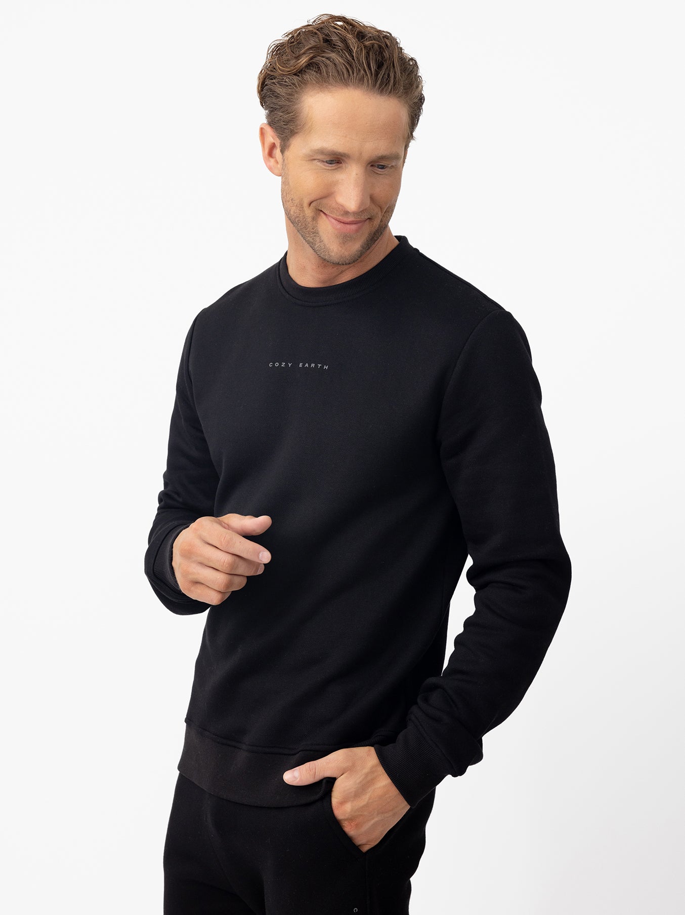 Man looking down wearing black cityscape crewneck 