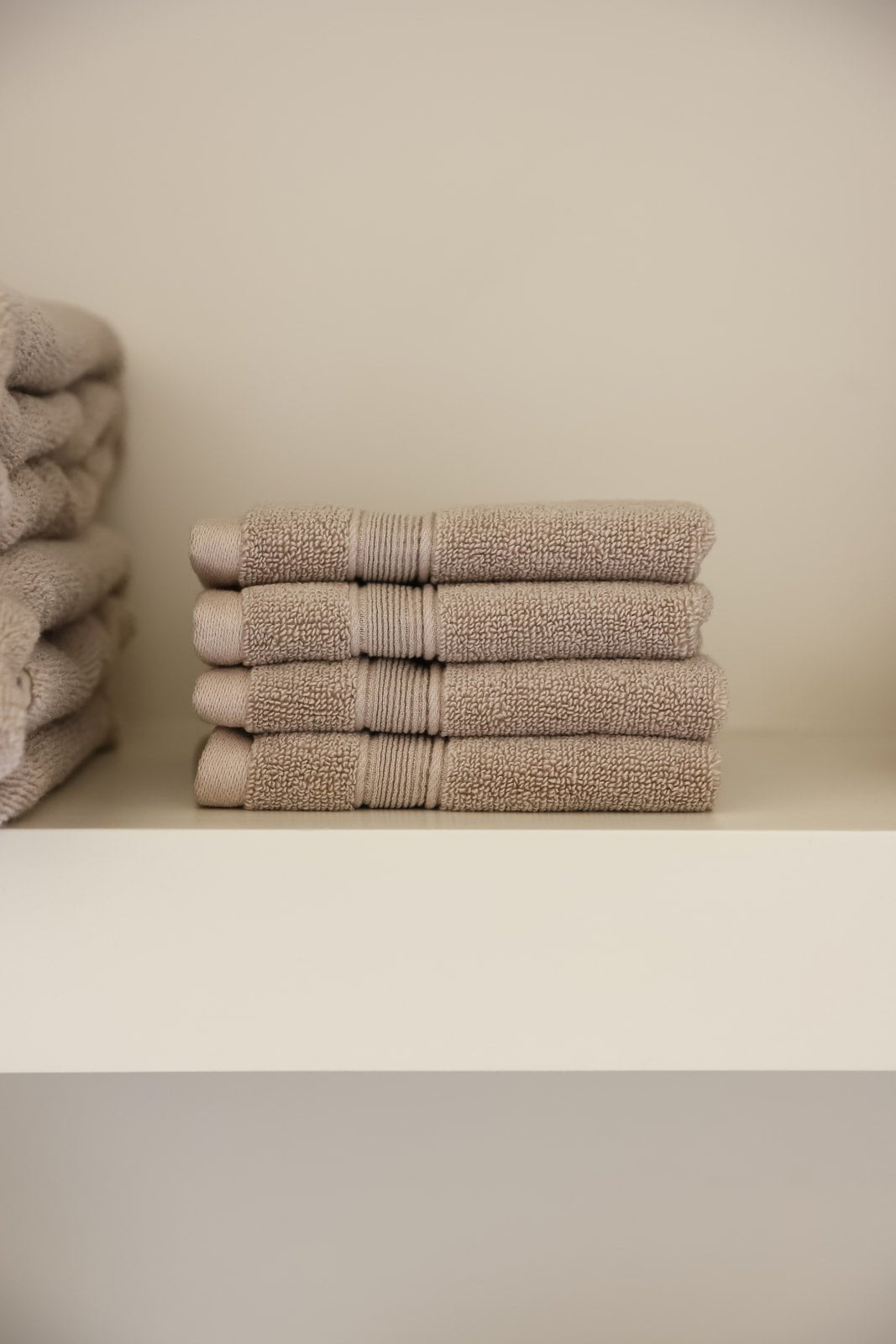 Sand washcloths folded on shelf 