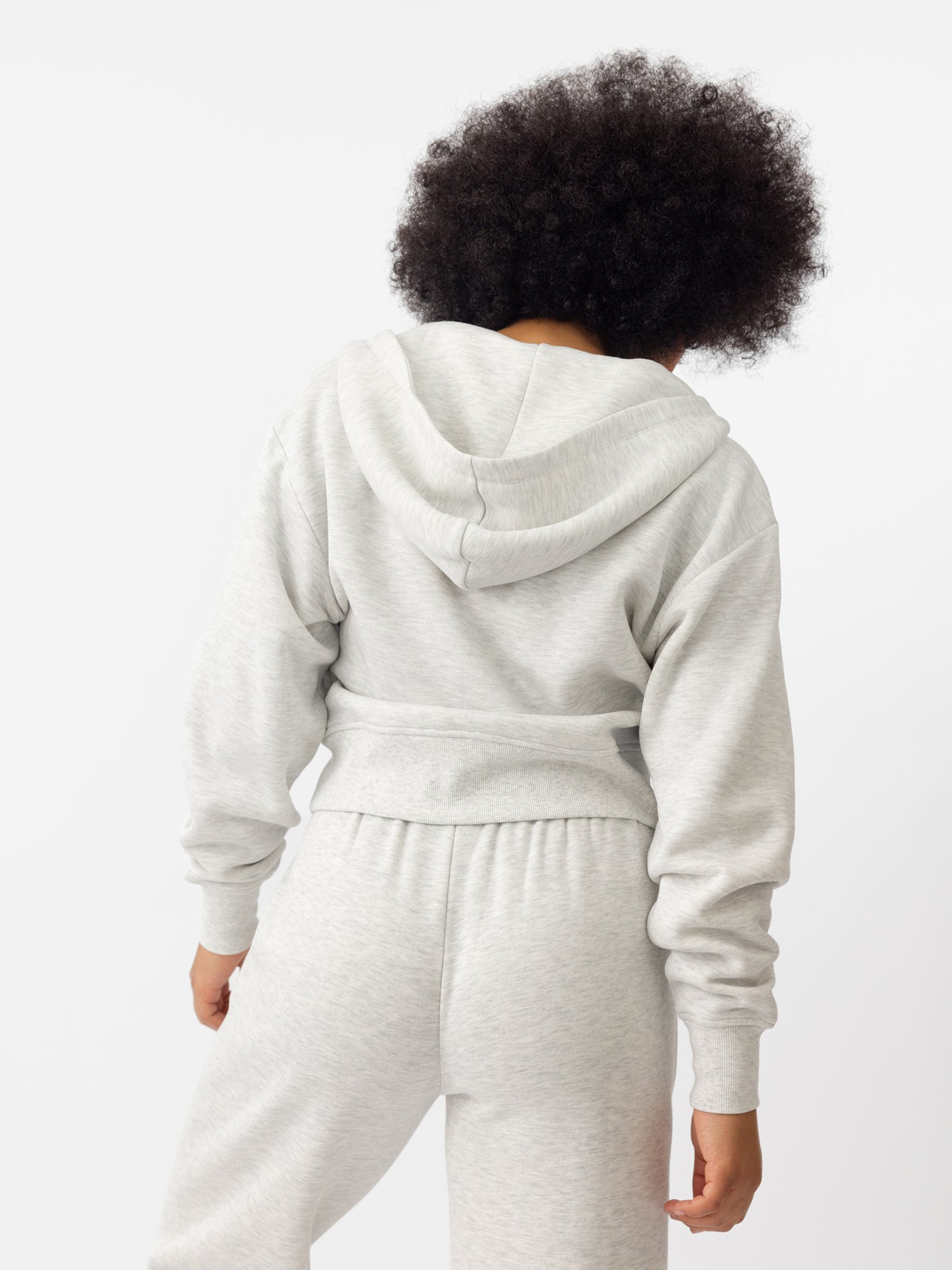 Woman wearing Heather Grey CityScape Cropped Full Zip with white background 