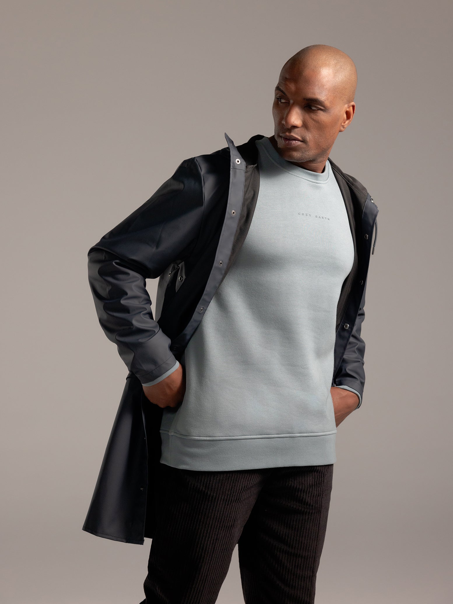 Man wearing Smokey Blue cityscape crewneck with grey background 