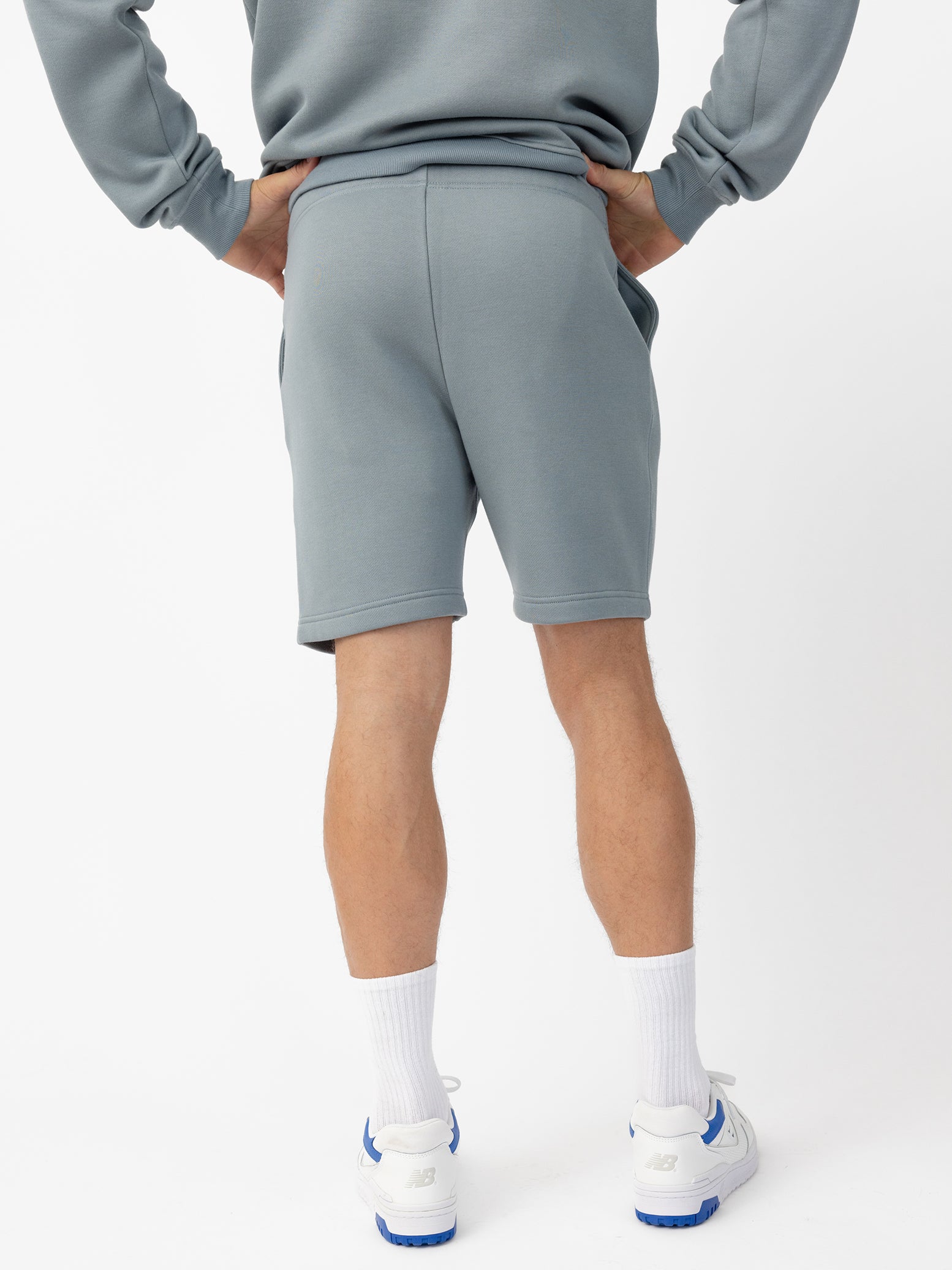 Man wearing Smokey Blue CityScape Shorts with white background 