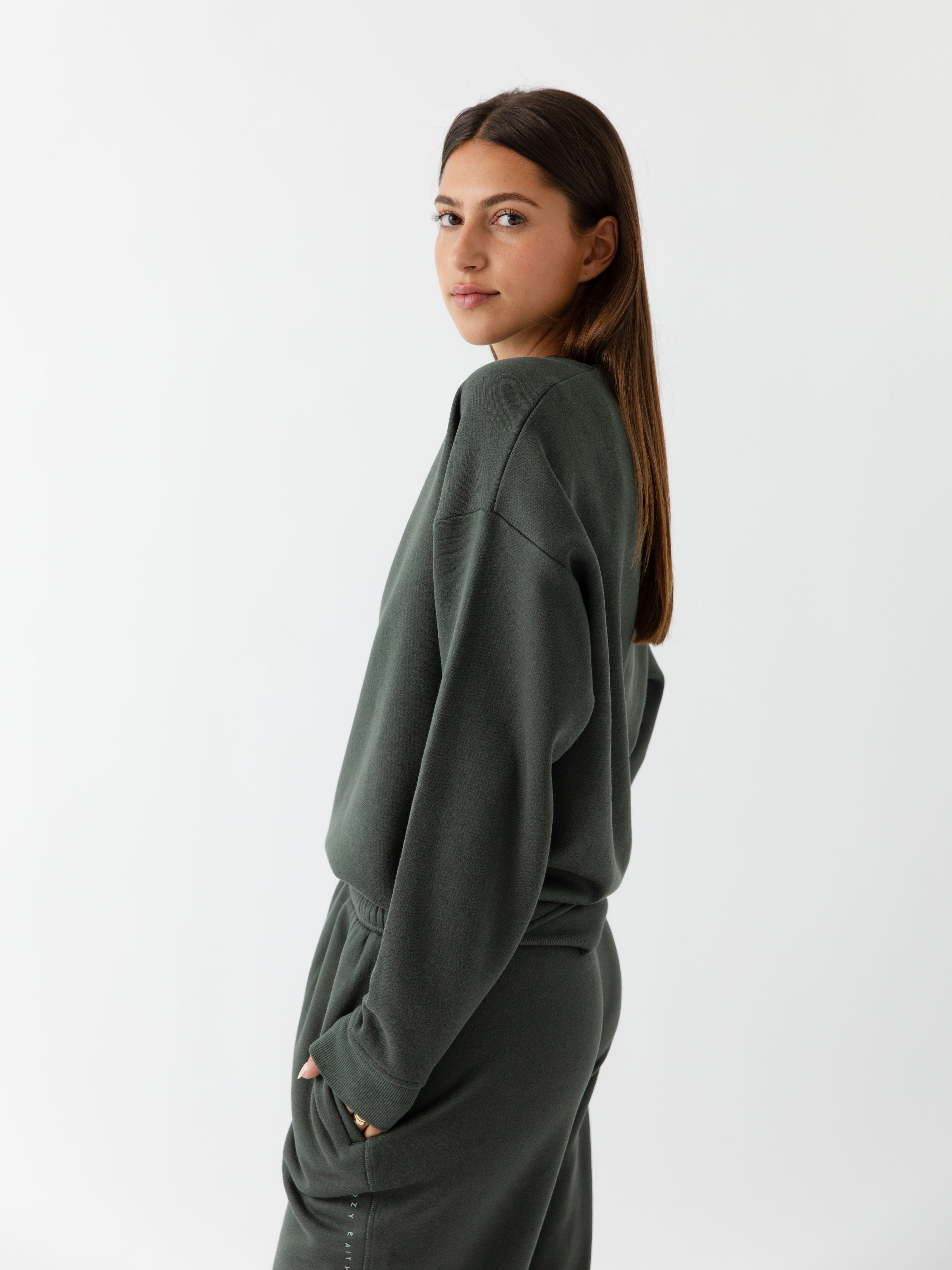Storm CityScape Pullover Crew. The Pullover is being worn by a female model. Accompanying city scape clothing is being worn to complete the look of the outfit. The photo was taken with a white background. |Color:Storm