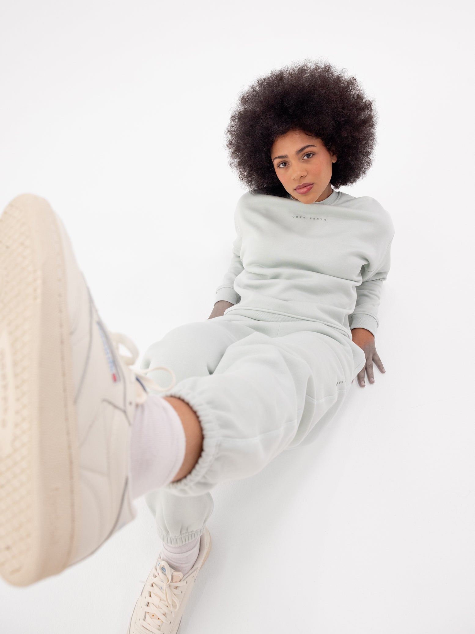 Arctic CityScape Joggers. The Joggers are being worn by a female model. The photo is taken with the models hand by the pocket of the joggers. The back ground is a crisp white background. 
