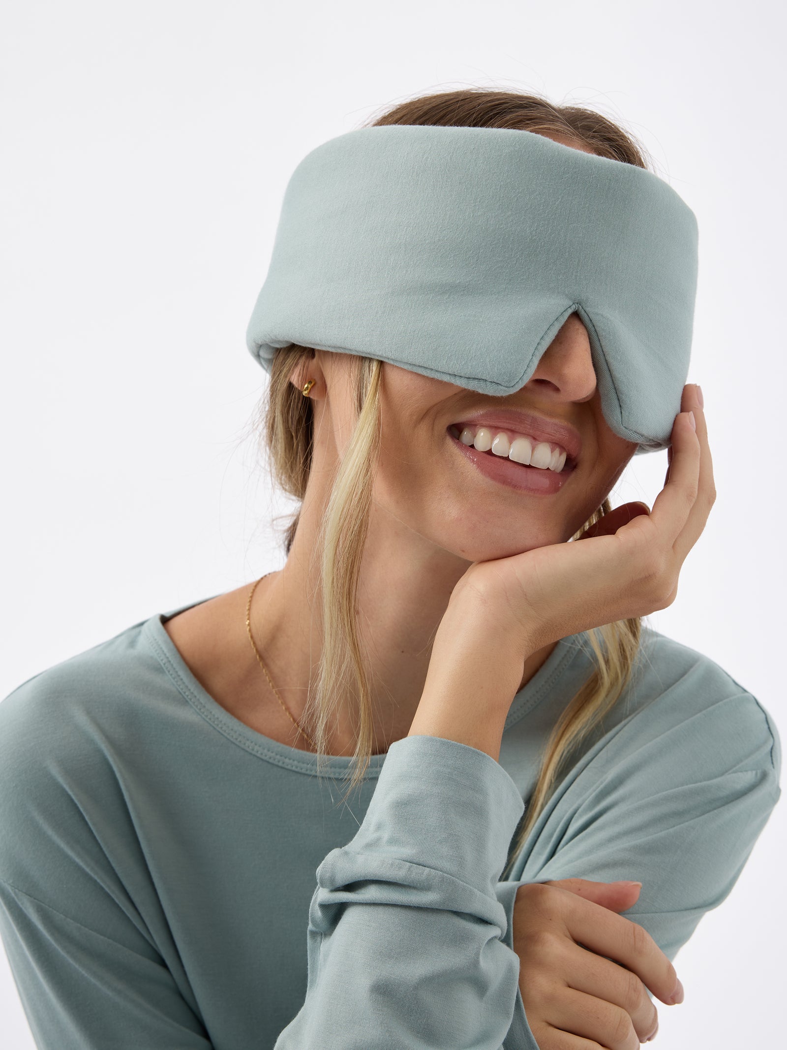 A woman wears the Cozy Earth Adjustable Bamboo Sleep Mask in Brook. 