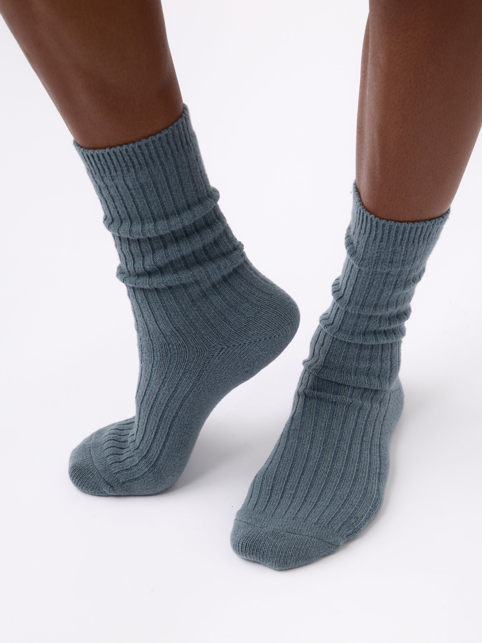 Person wearing Cozy Earth Plush Lounge Sock 1-Pack in Deep Blue 