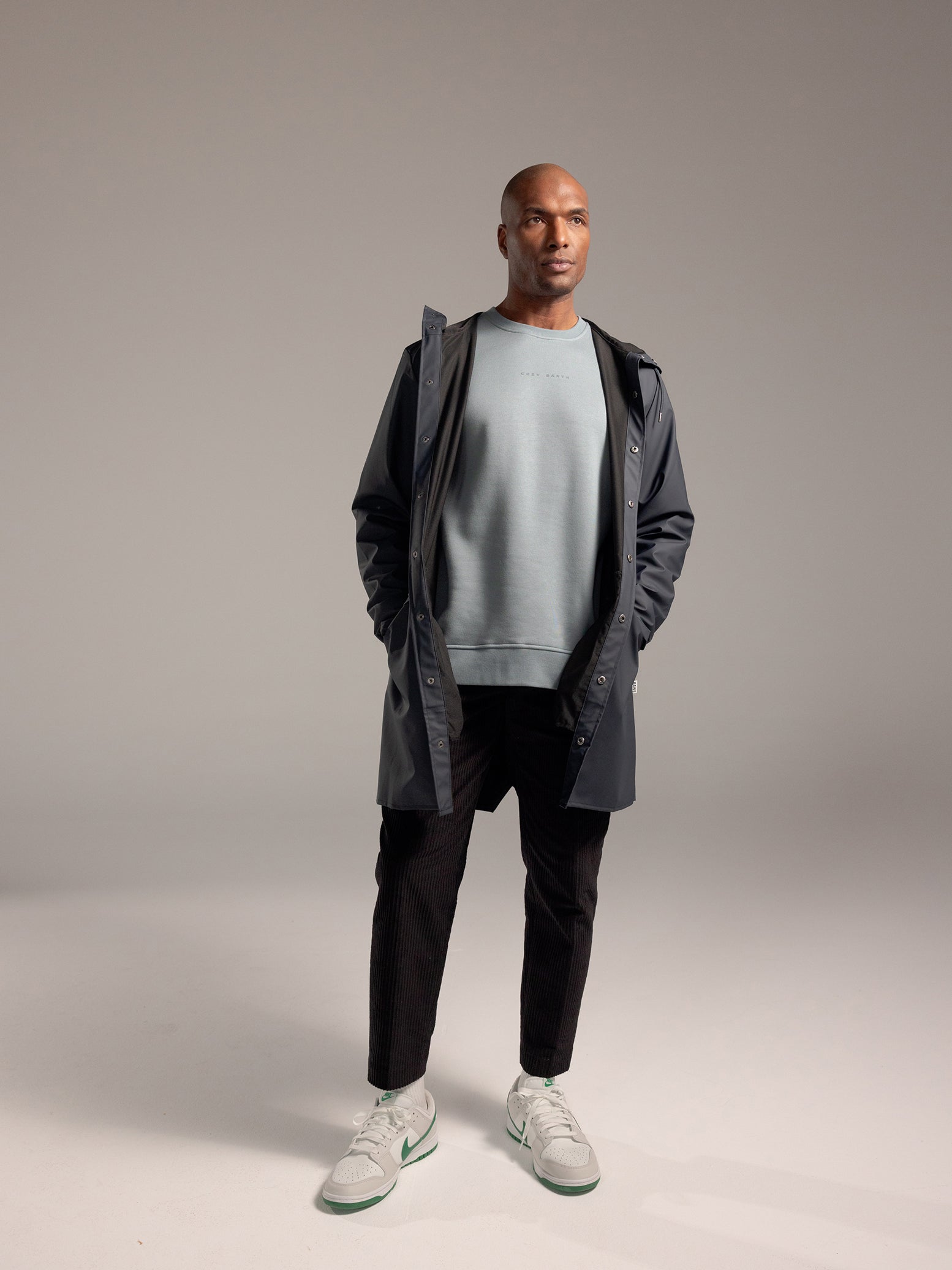 Man wearing Smokey Blue cityscape crewneck with grey background 