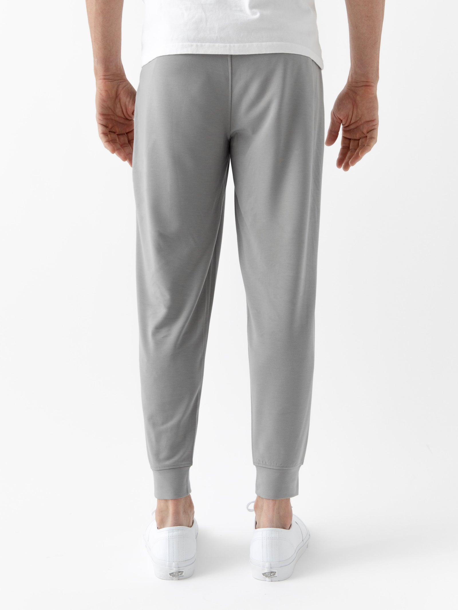 Burgundy/Light GreyMen's Bamboo Jogger Set. There is a man wearing the jogger set. He is standing in a well lit room in a home.
