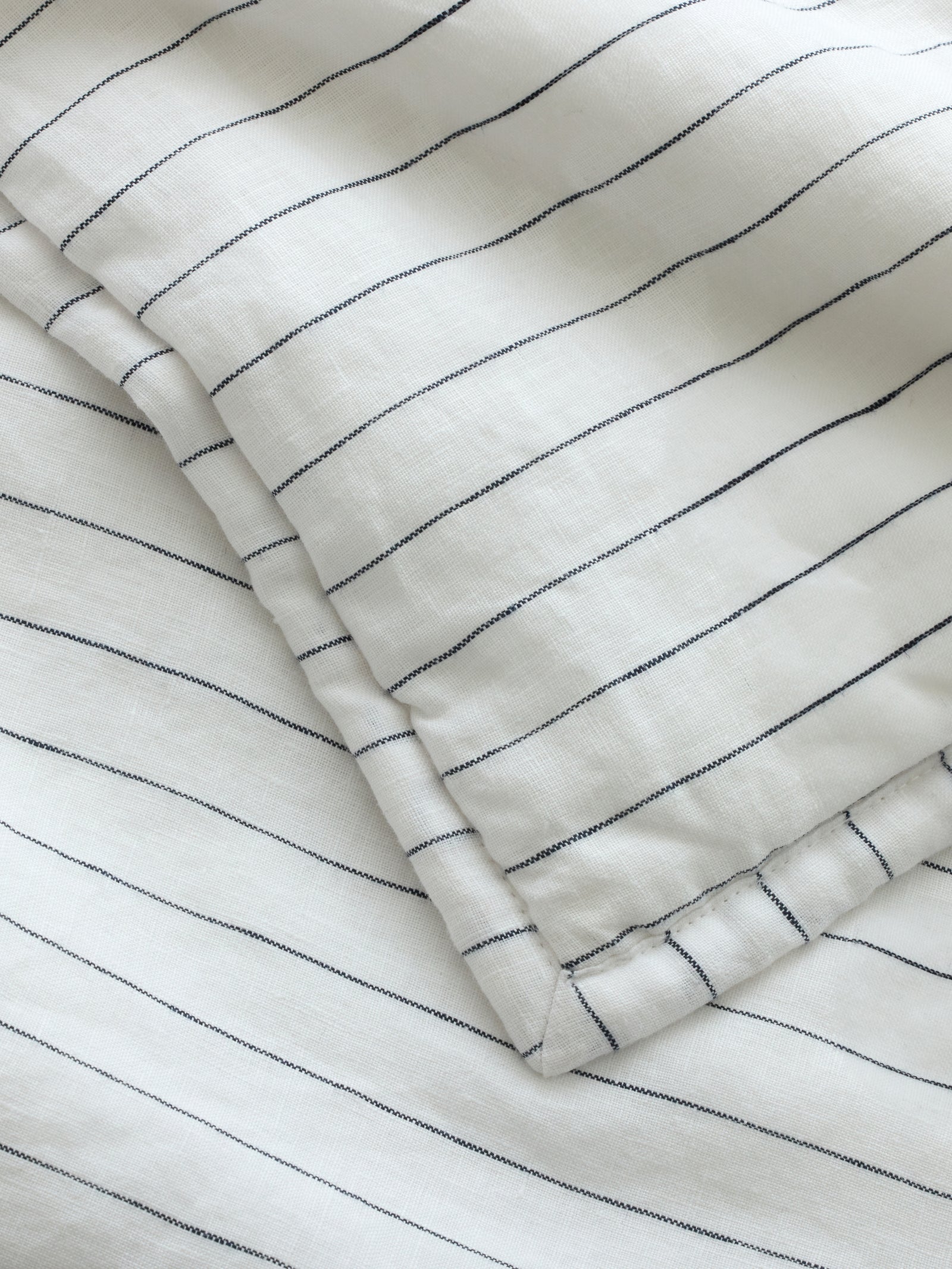 Close up of charcoal pencil stripe fabric 