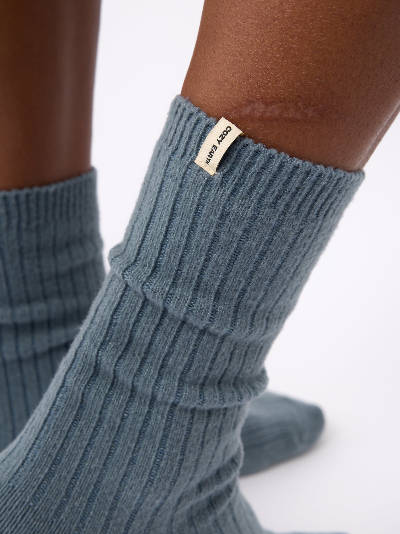 Close-up of the tag on Cozy Earth Plush Lounge Sock 1-Pack in Deep Blue 