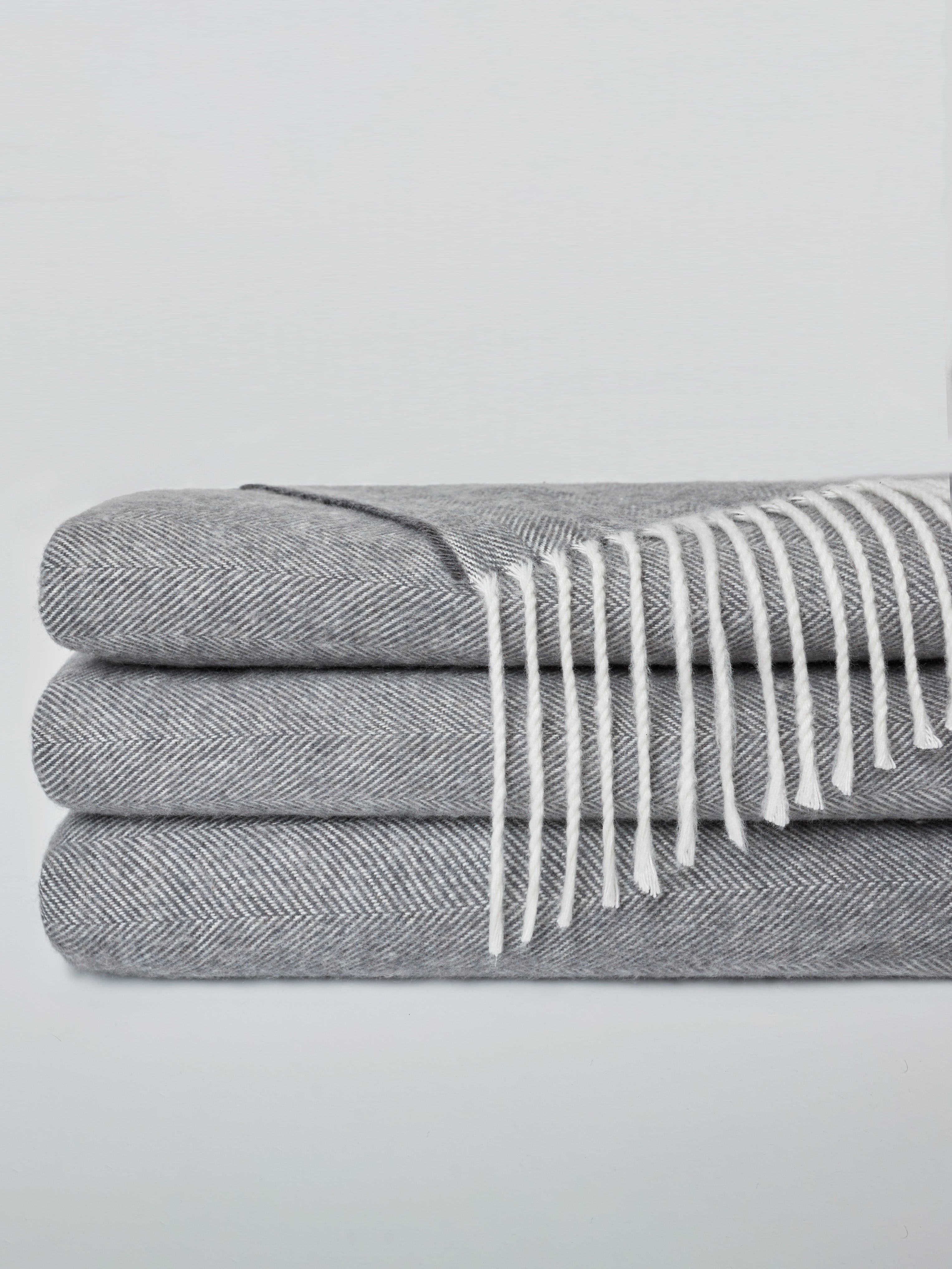 Shadow colored tassel throw folded with off-white background |Color:Shadow