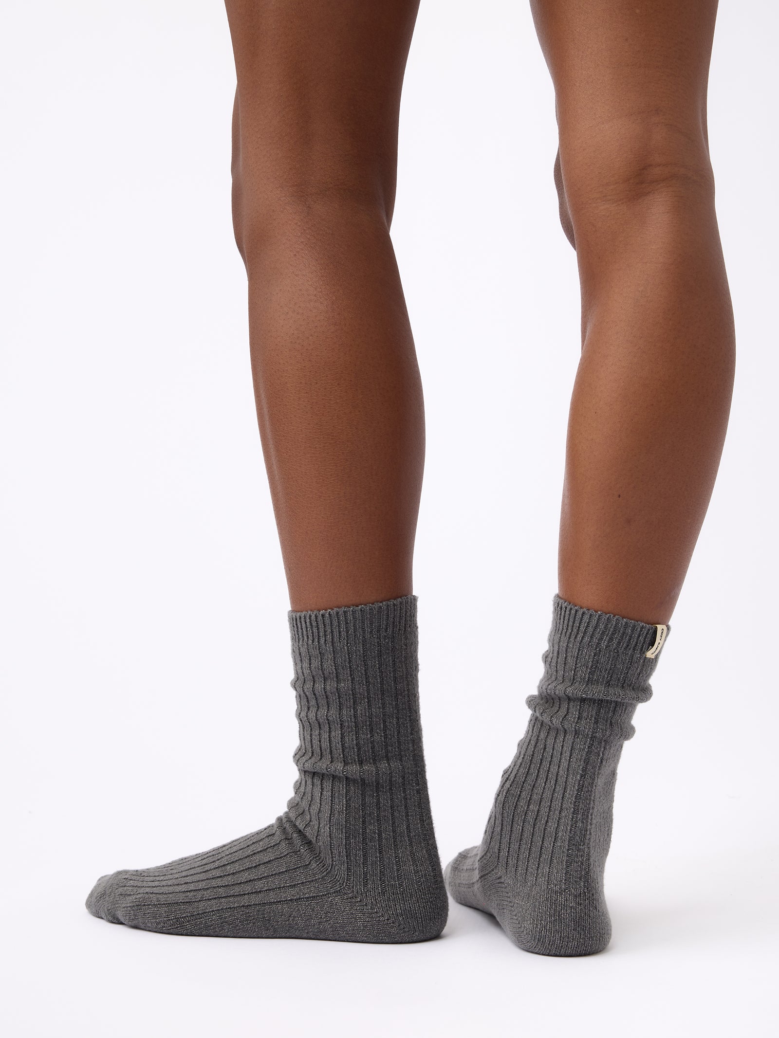 Person wearing Cozy Earth Plush Lounge Sock in Coal 