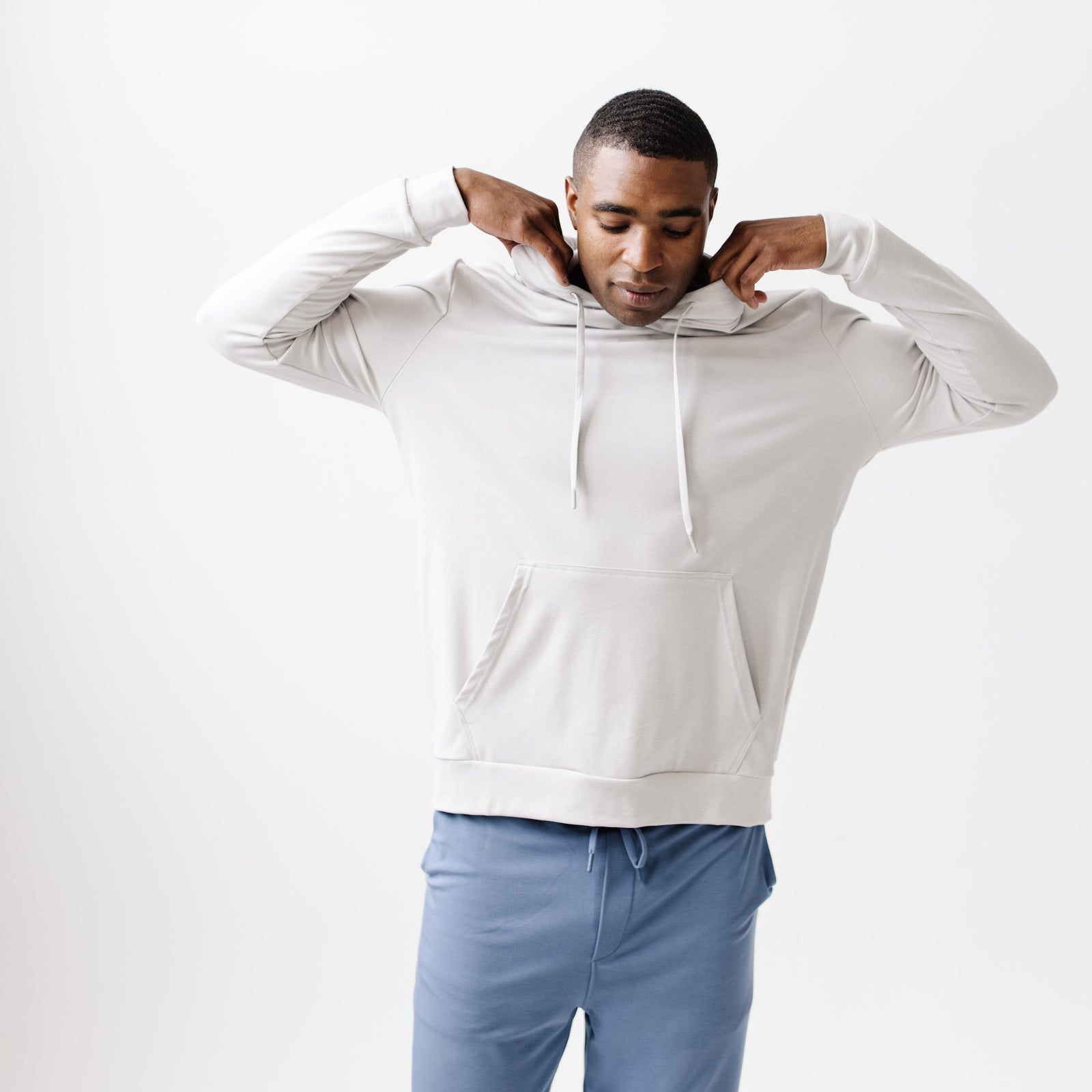 Light Grey Bamboo Hoodie worn by a man standing in front of white background.